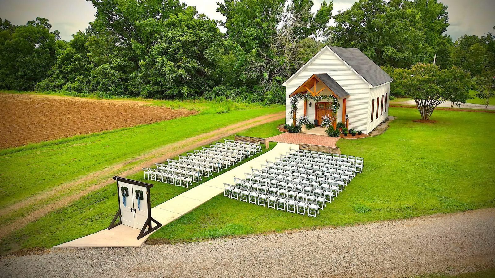 Aerial view of an outdoor ceremony in front of the chapel at Alvastage Acres, Duck Hill, Mississippi
