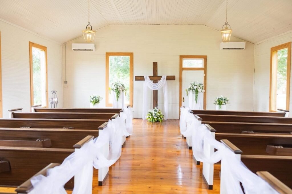 Chapel interior at Alvastage Acres with wooden pews and a center aisle